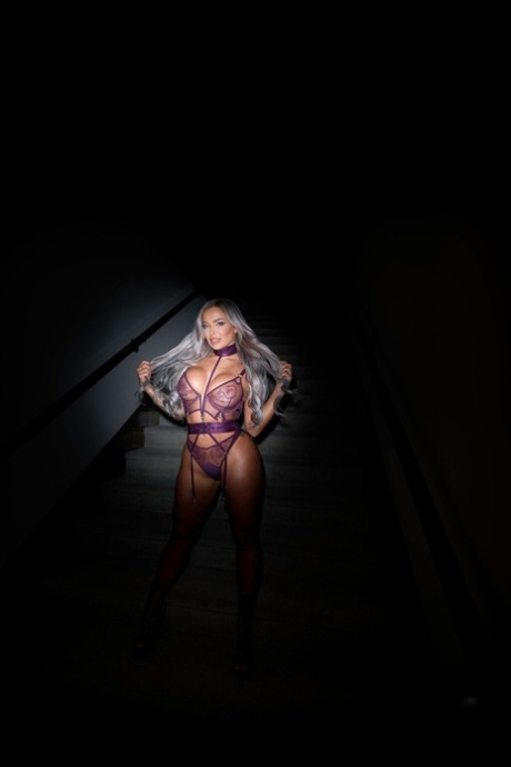 Platinum-blonde pornstar Hayley Davies shows her curves in her lingerie