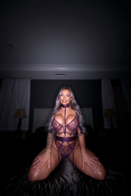 Platinum-blonde pornstar Hayley Davies shows her curves in her lingerie