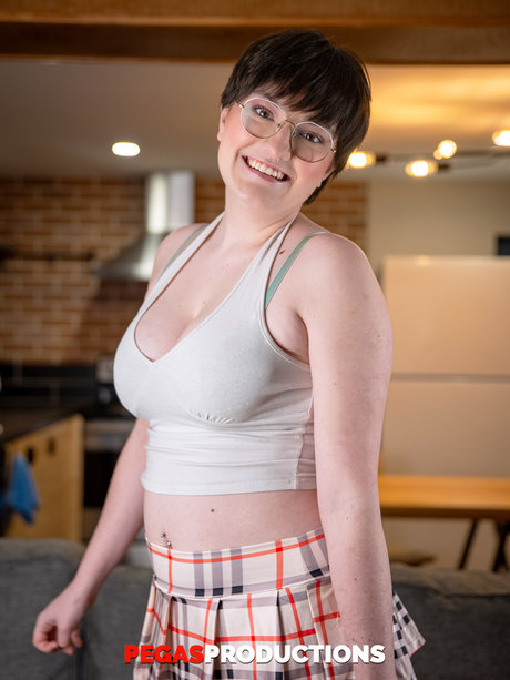 Busty brunette Kitty Kunt flaunts her big boobs during a sexy striptease