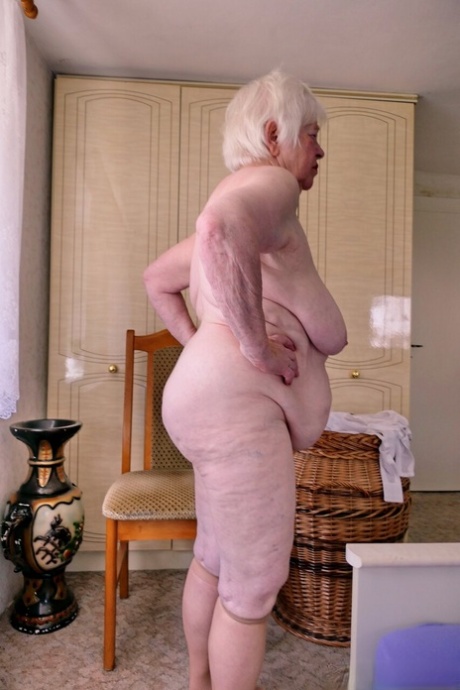 Playful granny Zizoresta puts a mask on before showing her huge saggy tits