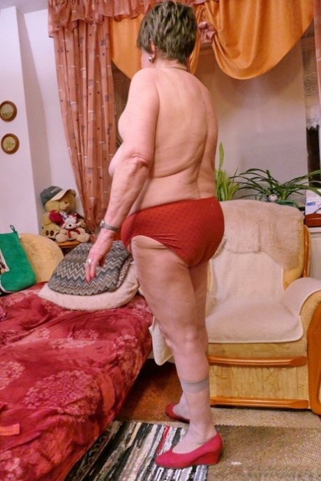 Naughty granny Prolet shows off her saggy tits while undressing