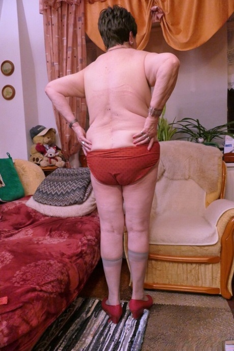 Naughty granny Prolet shows off her saggy tits while undressing