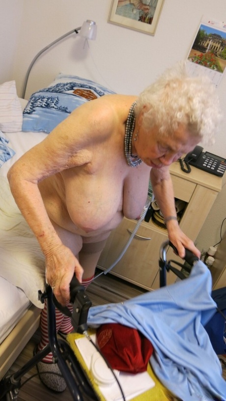 Kinky old granny Ornella poses naked and teases with her huge juggs