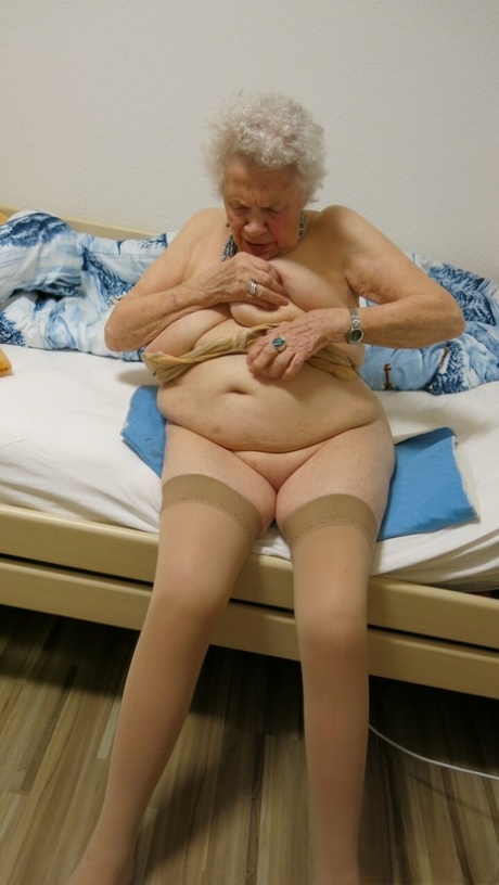 Kinky old granny Ornella poses naked and teases with her huge juggs