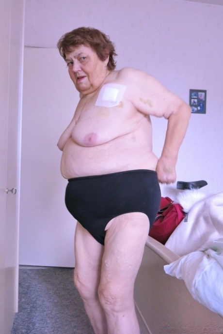 Naughty granny Kurra strips completely naked & shows off her saggy tits