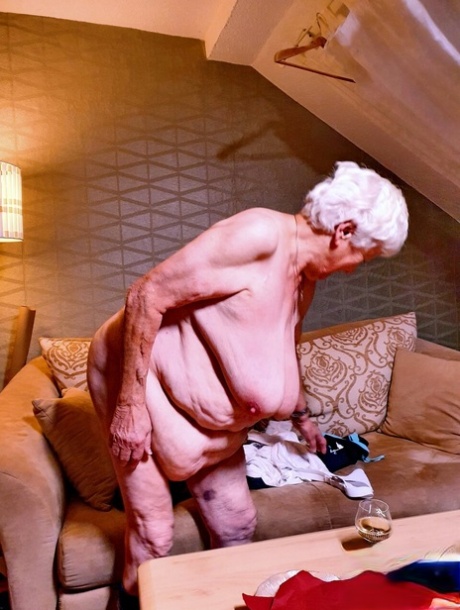 Naughty chubby granny Modesta shows her saggy tits while completely naked