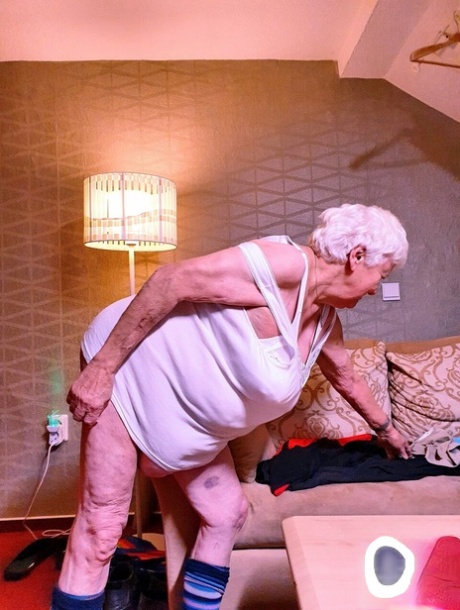 Naughty chubby granny Modesta shows her saggy tits while completely naked