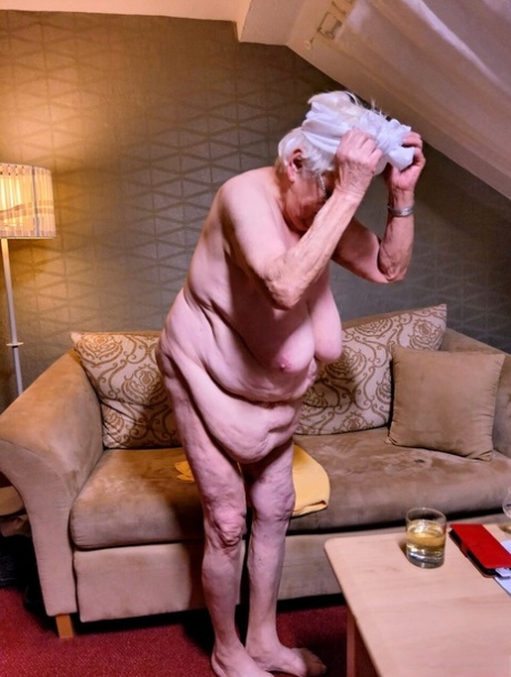 Naughty chubby granny Modesta shows her saggy tits while completely naked