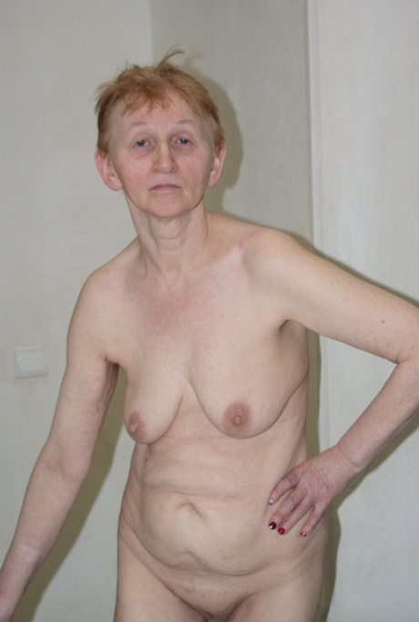 Nasty granny Arina strips and exposes her saggy tits, flat ass & old holes
