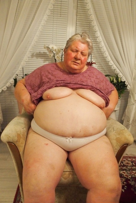 Fat granny Clotilde unveils her saggy tits and sucks a sex toy in a solo