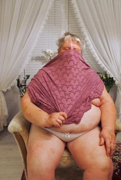 Fat granny Clotilde unveils her saggy tits and sucks a sex toy in a solo
