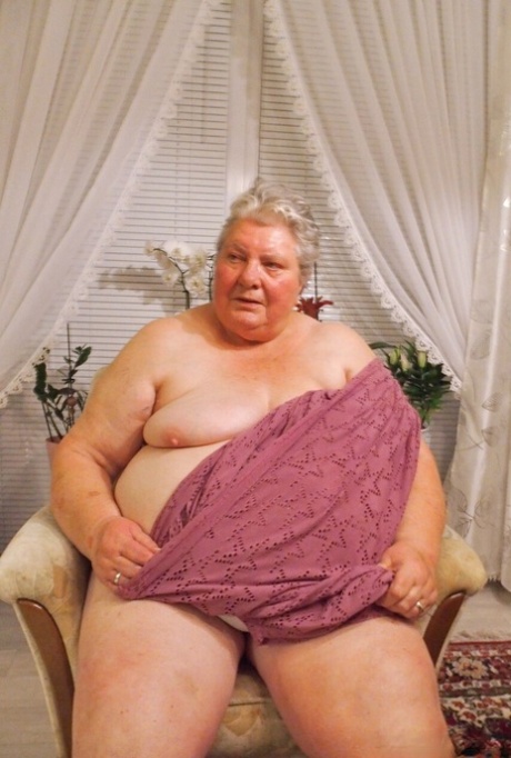Fat granny Clotilde unveils her saggy tits and sucks a sex toy in a solo