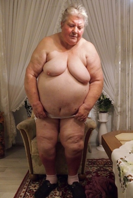 Fat granny Clotilde unveils her saggy tits and sucks a sex toy in a solo
