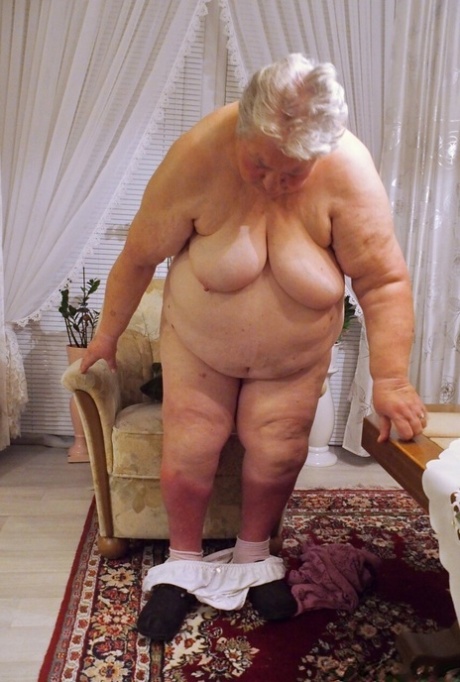 Fat granny Clotilde unveils her saggy tits and sucks a sex toy in a solo