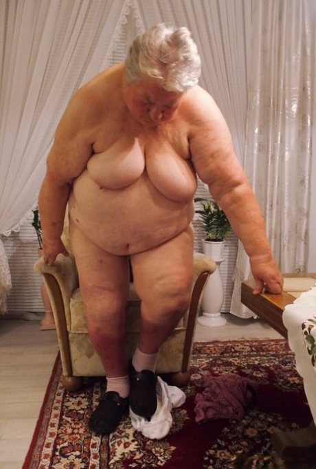 Fat granny Clotilde unveils her saggy tits and sucks a sex toy in a solo