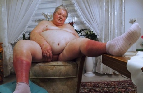 Fat granny Clotilde unveils her saggy tits and sucks a sex toy in a solo