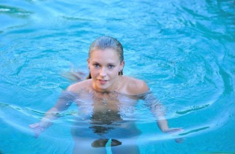 Acrobatic babe Lena poses naked by the pool after doing yoga topless