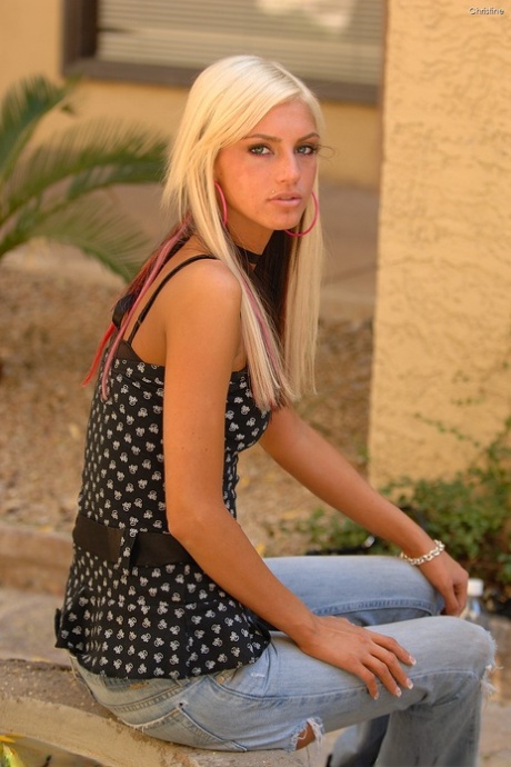 Horny babe with a pierced belly Christine flaunts her small tits in a solo